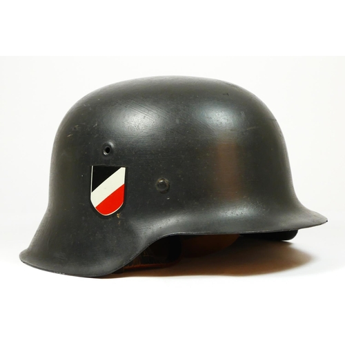 386 - A WWII German double decal helmet, with German Tricolour to one side and Eagle to the other, repaint... 