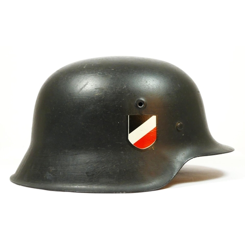 386 - A WWII German double decal helmet, with German Tricolour to one side and Eagle to the other, repaint... 