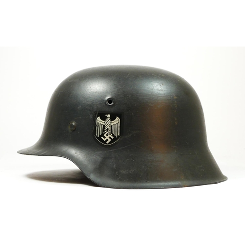 386 - A WWII German double decal helmet, with German Tricolour to one side and Eagle to the other, repaint... 