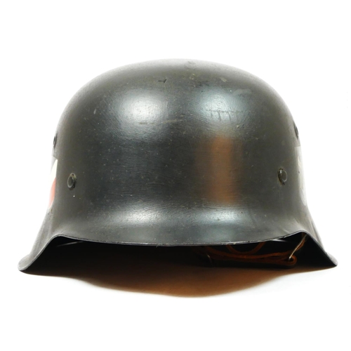 386 - A WWII German double decal helmet, with German Tricolour to one side and Eagle to the other, repaint... 