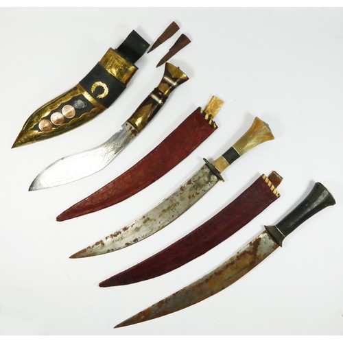 410 - A Kukri with brass inlaid hard wood hilt, brass applied leather scabbard, and two Indian knives with... 