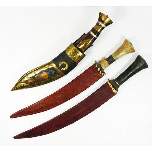 410 - A Kukri with brass inlaid hard wood hilt, brass applied leather scabbard, and two Indian knives with... 