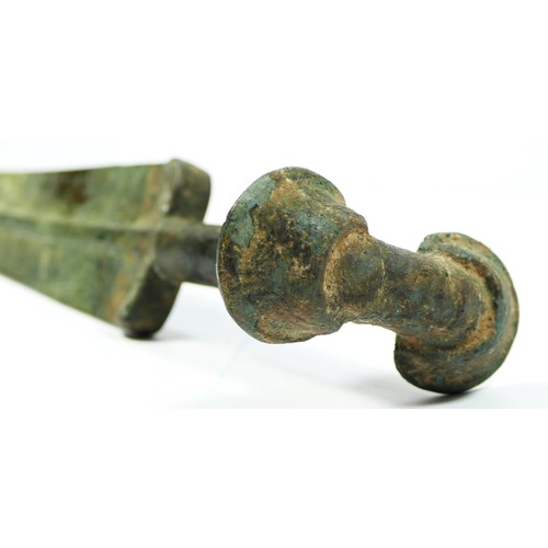 413 - A Luristan bronze short sword, with pronounced central ribbed blade and ear pommel, 47cm.
Provenance... 