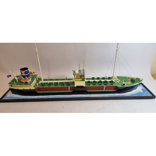 83 - Grit, coastal tanker model, plastic hull and superstructure, glass display case, with sea diorama ba... 