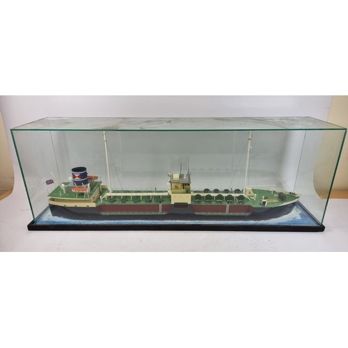 83 - Grit, coastal tanker model, plastic hull and superstructure, glass display case, with sea diorama ba... 