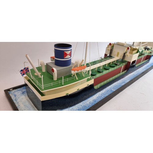 83 - Grit, coastal tanker model, plastic hull and superstructure, glass display case, with sea diorama ba... 