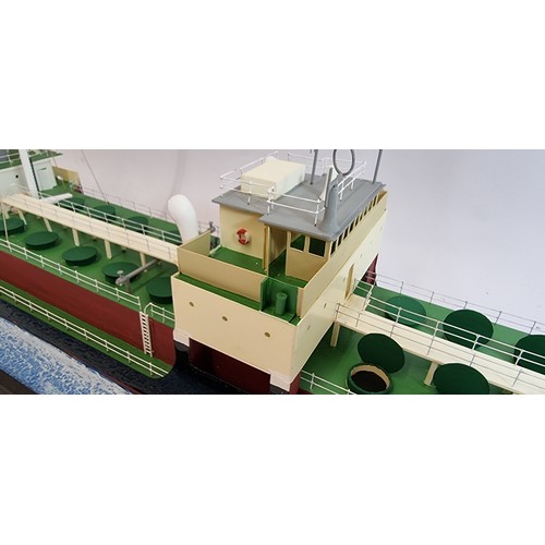 83 - Grit, coastal tanker model, plastic hull and superstructure, glass display case, with sea diorama ba... 