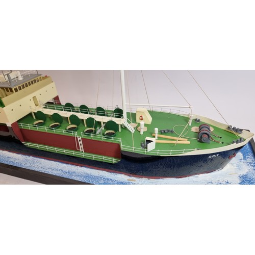 83 - Grit, coastal tanker model, plastic hull and superstructure, glass display case, with sea diorama ba... 