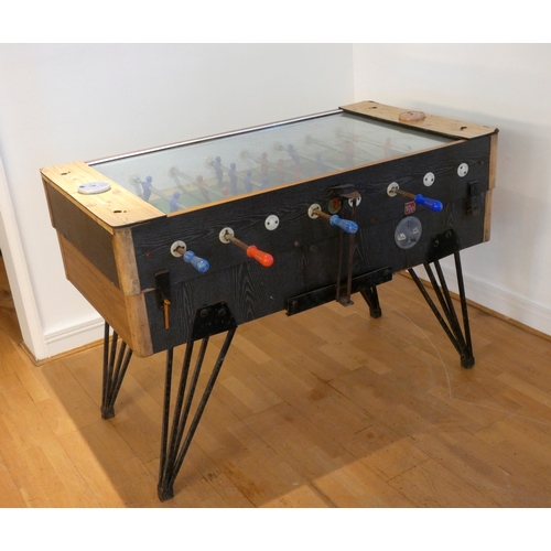 309 - A unbranded football/foosball table, veneered case, glass hinged top, red and blue teams, on tapered... 