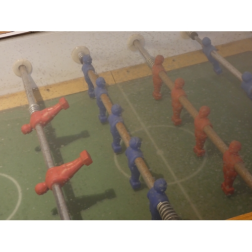 309 - A unbranded football/foosball table, veneered case, glass hinged top, red and blue teams, on tapered... 