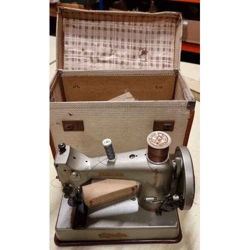 262 - A Jones Popular cast iron hand propelled sewing machine in case.