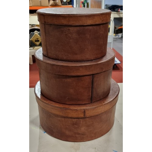 259 - Three tan leather circular boxes, 37cm, 31, 27cm