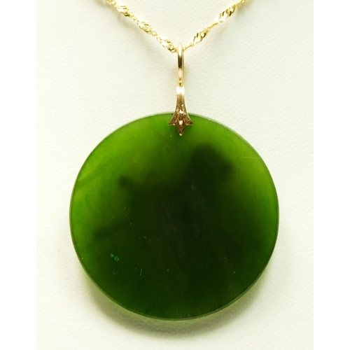 22 - A 14K gold and nephrite jade disc pendant with applied horse motif, diam 30mm, chain