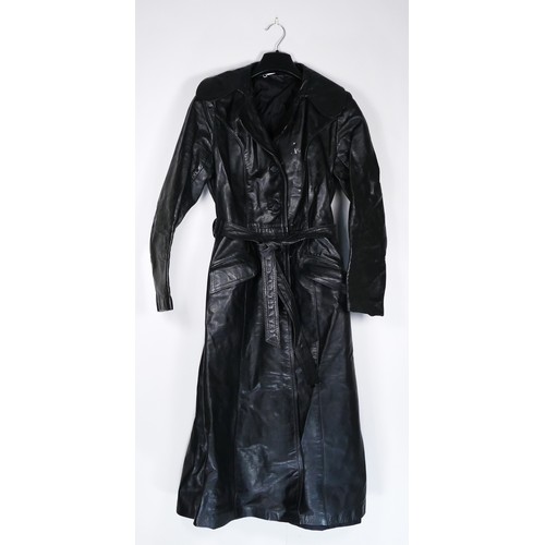 131 - A full length black, button through, single vented belted leather coat purchased around 1977, size 3... 