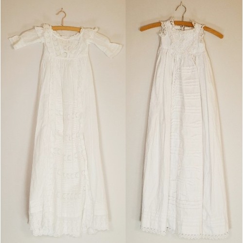 143 - Two white christening gowns, one short sleeved with lace flower detailing around chest and at hem li... 