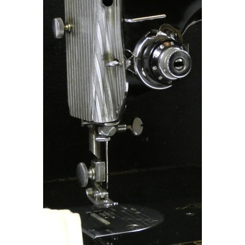 An early 20th century electric Singer sewing machine model 221K