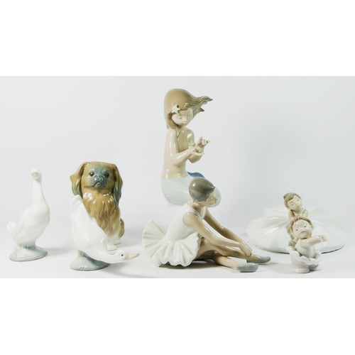 81 - A Lladro ceramic model of a dog, together with six Nao figurines. (7).