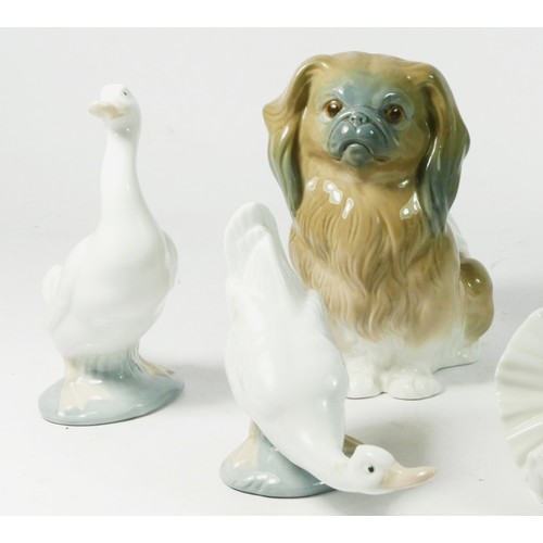 81 - A Lladro ceramic model of a dog, together with six Nao figurines. (7).