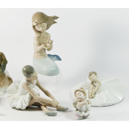 81 - A Lladro ceramic model of a dog, together with six Nao figurines. (7).