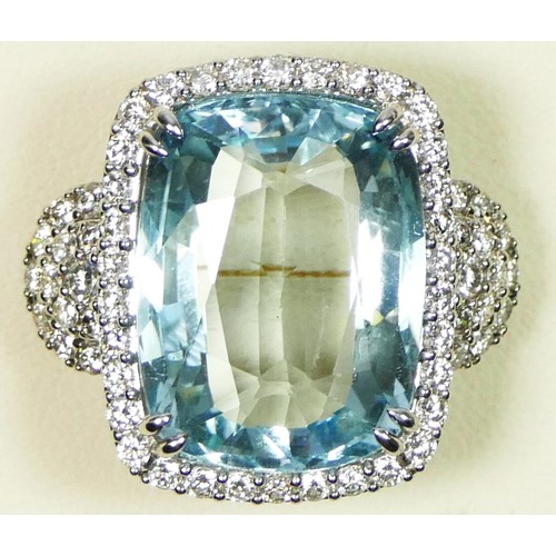 98 - A 18ct white gold, aquamarine and diamond dress ring, stamped 750, claw set with a 15.35ct stone, me...