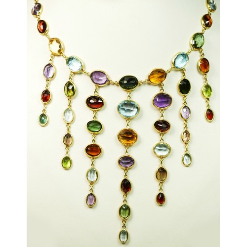 82 - An 18ct gold spectacle set multi-gemstone necklace, stamped 750, collet set with aquamarine, citrine... 