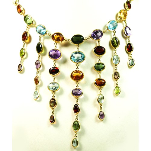 82 - An 18ct gold spectacle set multi-gemstone necklace, stamped 750, collet set with aquamarine, citrine... 