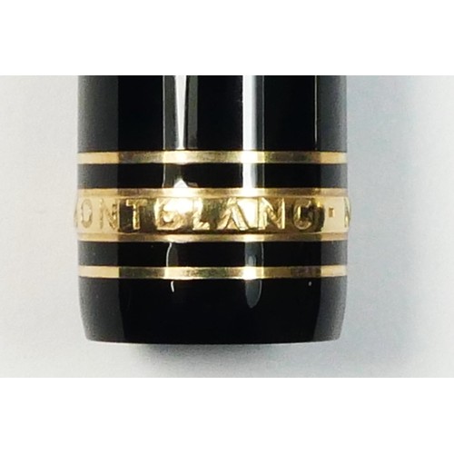 116 - Mont Blanc Meisterstuck, a black body and gold plated rollerball pen, c. 1996, clip ring number EK10... 