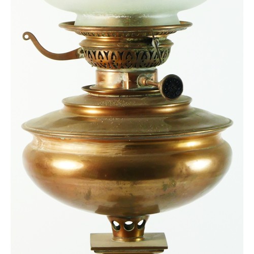 148 - An early 20th century brass and copper oil lamp, having frosted glass tulip shade with copper bowl, ... 