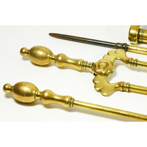 152 - A Victorian set of fire irons with Aesthetic Movement dog supports.