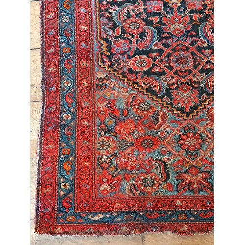 156 - A Persian Heriz long runner, with black, dark blue and red geometric field, 109 x 580cm