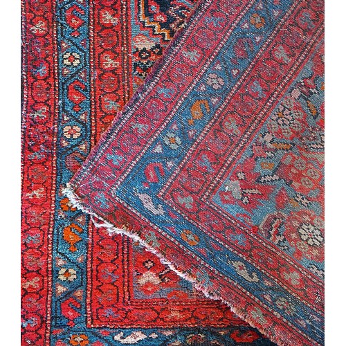 156 - A Persian Heriz long runner, with black, dark blue and red geometric field, 109 x 580cm