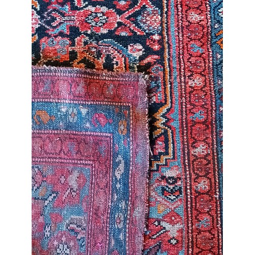 156 - A Persian Heriz long runner, with black, dark blue and red geometric field, 109 x 580cm