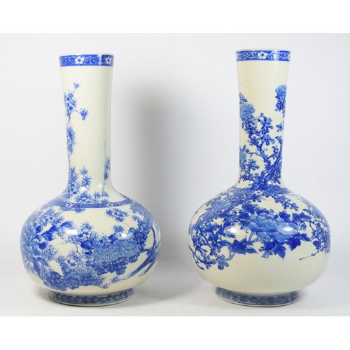 280 - A near pair of Japanese blue and white bulbous vases, Meiji period, underglaze decorated in the Hira... 