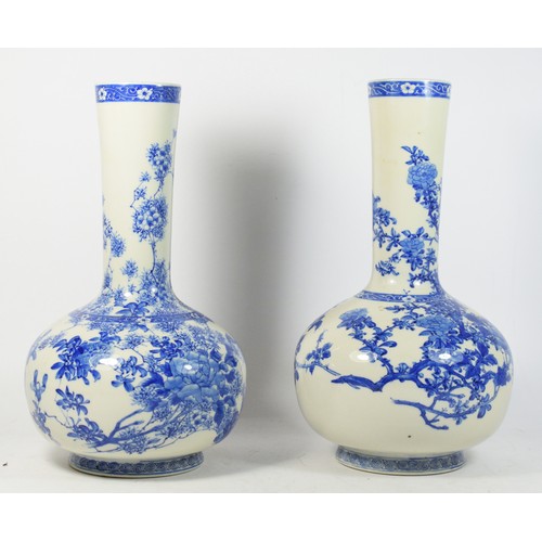 280 - A near pair of Japanese blue and white bulbous vases, Meiji period, underglaze decorated in the Hira... 