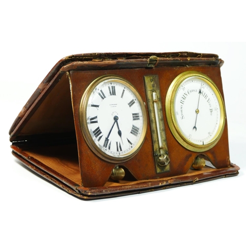 292 - An Edwardian travelling desk set, comprising an eight day clock, the white enamel dial with Edward, ... 