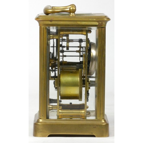 296 - An early 20th century carriage clock, with enamelled dial and Roman numerals, the brass case housing... 