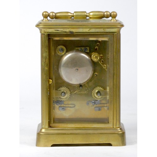 296 - An early 20th century carriage clock, with enamelled dial and Roman numerals, the brass case housing... 