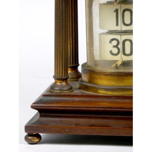 297 - A mahogany and brass 'Ticket' desk clock, of cylindrical form, housed by four reeded brass pillars o... 