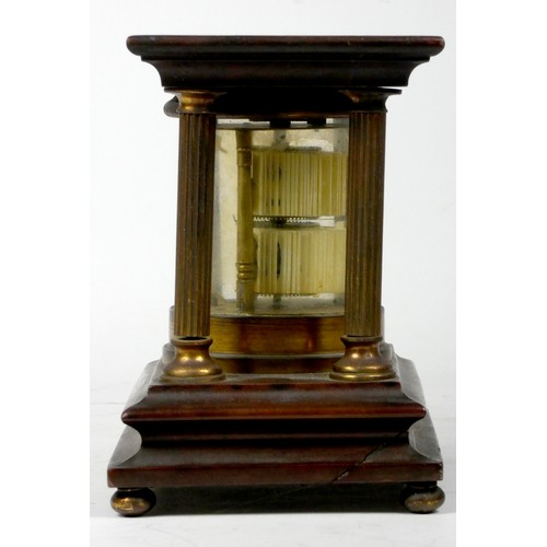 297 - A mahogany and brass 'Ticket' desk clock, of cylindrical form, housed by four reeded brass pillars o... 