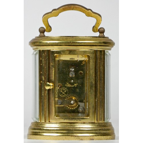 310 - A French miniature carriage clock, brass case of oval form with enamelled dial and Roman numerals, h... 