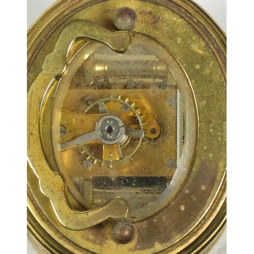 310 - A French miniature carriage clock, brass case of oval form with enamelled dial and Roman numerals, h... 