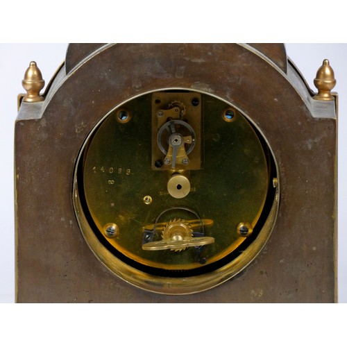 314 - An early 20th century French mantel clock, having arched top with burnished brass case and attached ... 