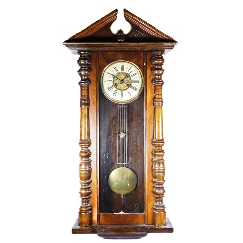 325 - A late 19th century walnut Vienna style wall clock, the movement striking on a gong, pendulum, key, ... 