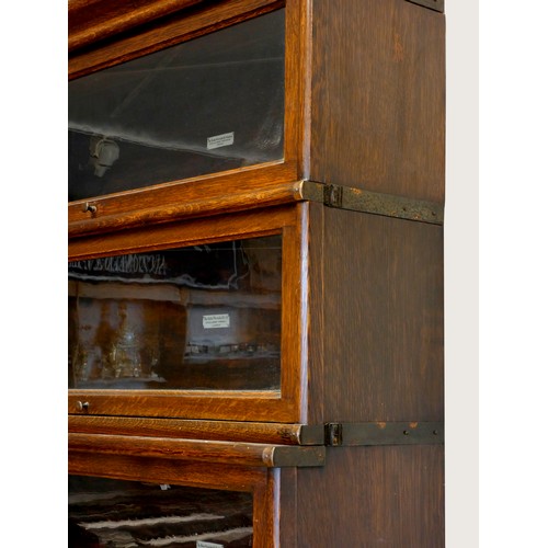 376 - An oak Globe Wernicke library bookcase, the five graduated glazed sections over a single drawer base... 