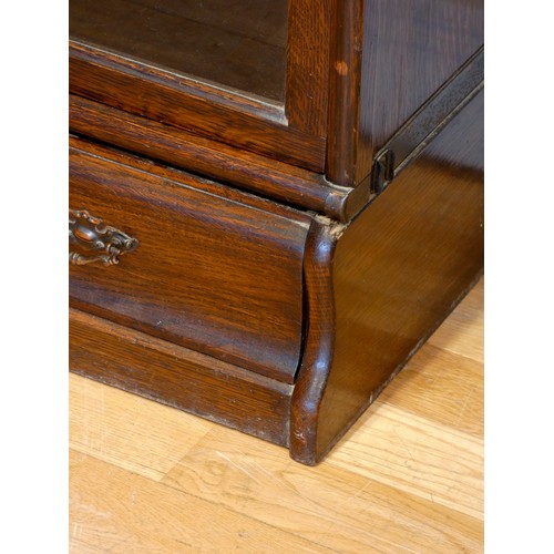 376 - An oak Globe Wernicke library bookcase, the five graduated glazed sections over a single drawer base... 