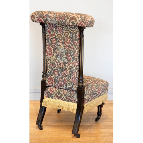 384 - A Victorian prie dieu or Prayer chair, having ebonised reeded supports with  tapestry upholstered se... 