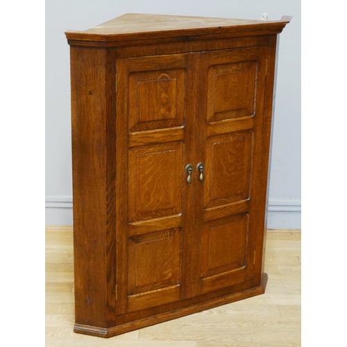 386 - An Arts & Crafts style oak wall hanging corner cabinet by David Muir of Crayke, Maple Leaf Man, the ... 