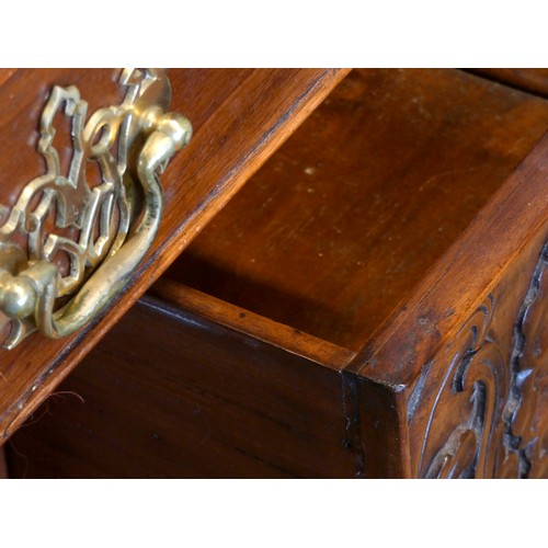 388 - An Indonesian carved hardwood lowboy, the plain top with applied moulded edge over two long and two ... 