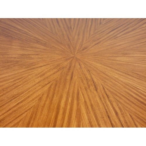 364 - A circular mahogany dining table, c.1960/70's, with sunburst pattern and eight stylised sectional bo... 