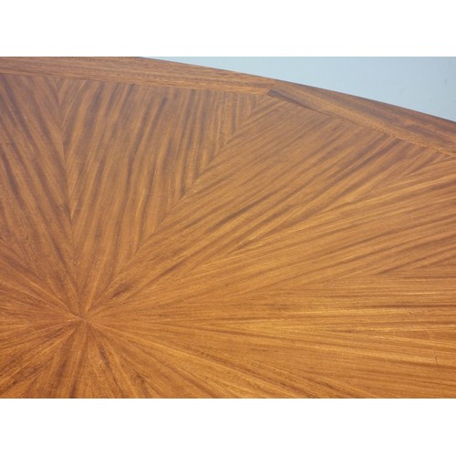 364 - A circular mahogany dining table, c.1960/70's, with sunburst pattern and eight stylised sectional bo... 